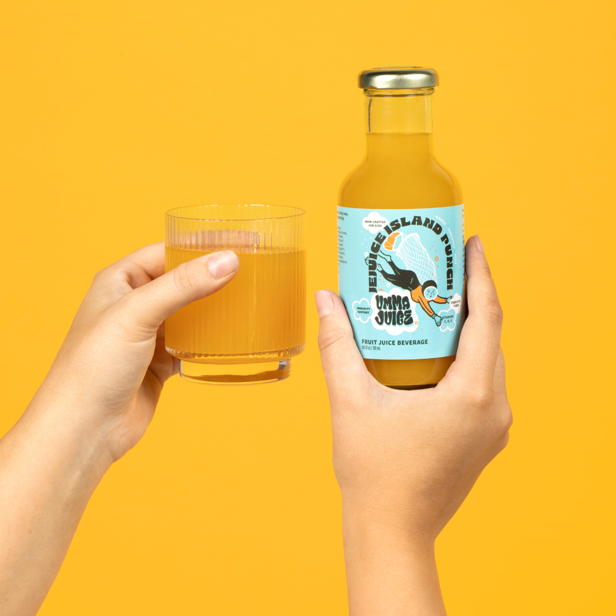 Two hands holding a glass  and bottle of Jejuice Island Punch against a yellow background